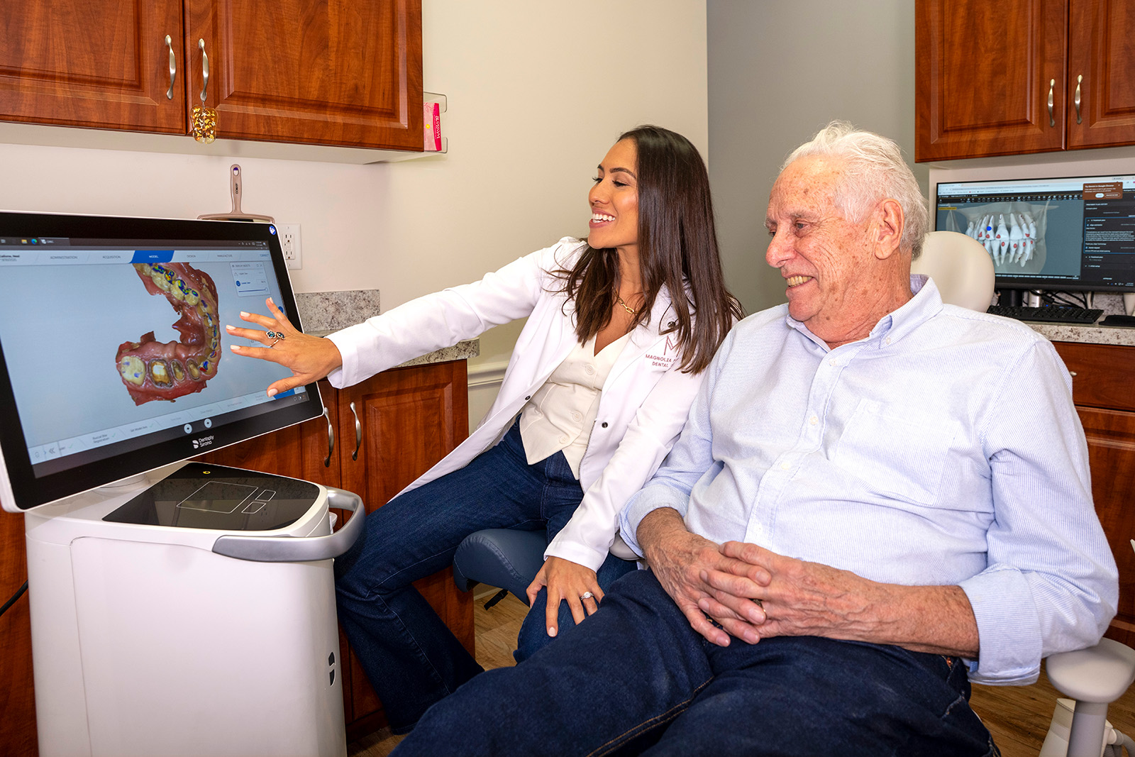 Dr. Rodriguez showing a patient a 3D teeth model on a scanner