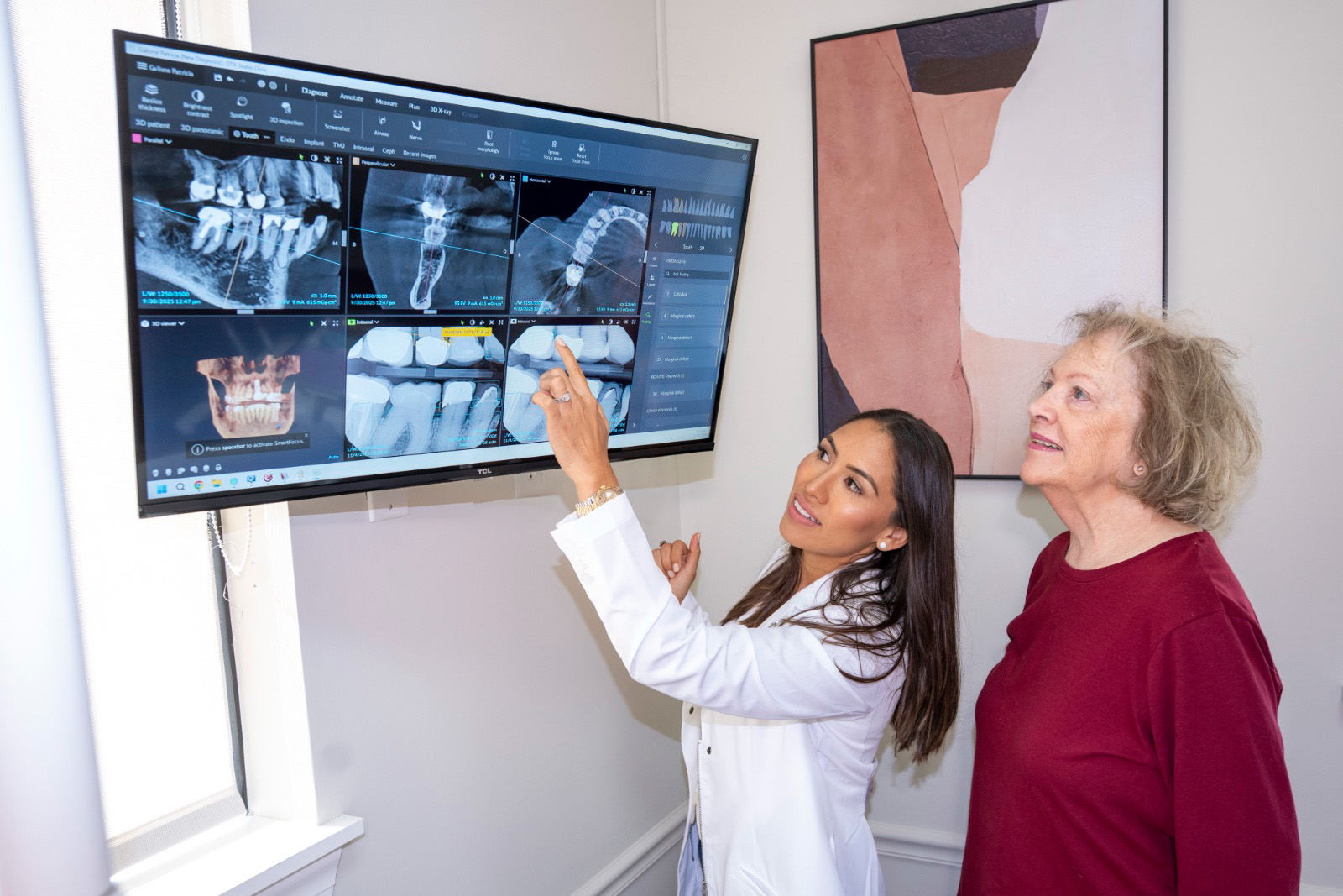 Dr. Rodriguez showing a patient some X-rays on a screen